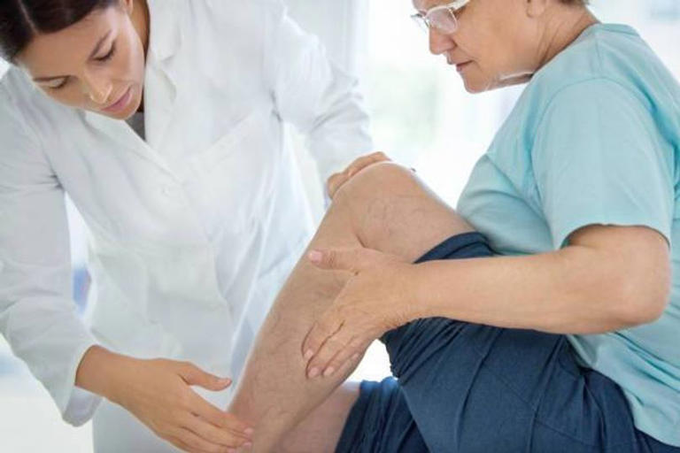 Doctor looking at patient's leg