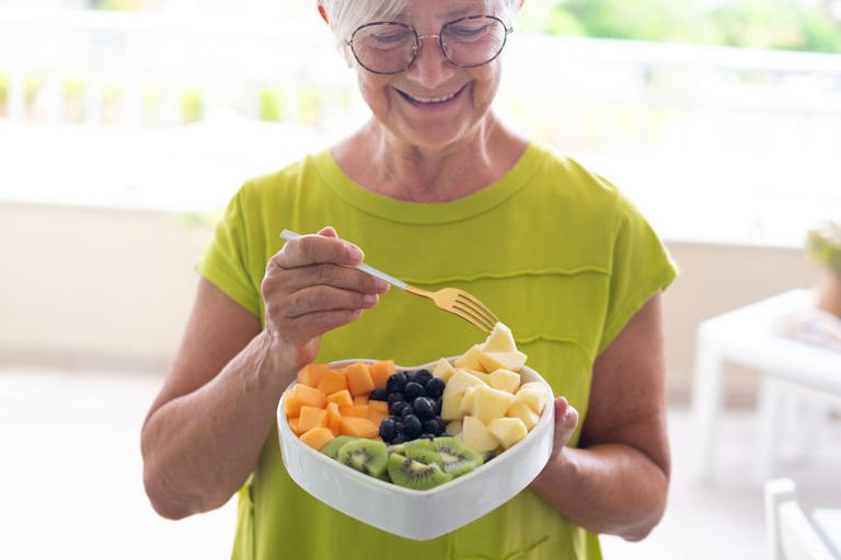 Woman eating fruit