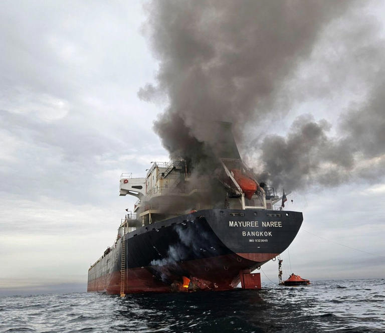 A Thai bulk carrier on fire after a missile strike in the Strait of Hormuz, where hostilities have crippled global shipping