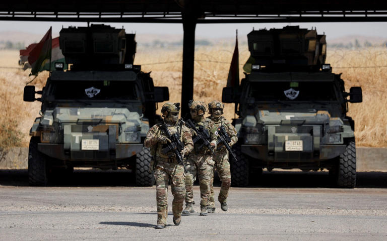 Members of Kurdish special forces patrol on the outskirts of Erbil, Iraq