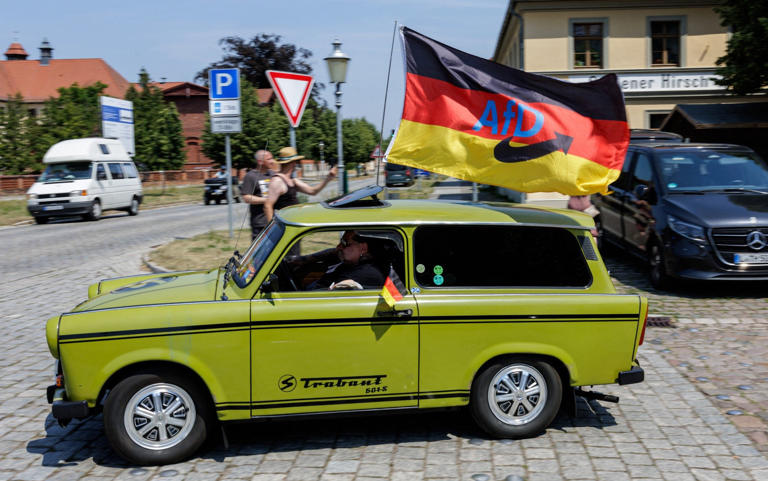 A Trabant car with an AfD party flag on its roof during election campaigning in Oranienbaum in June