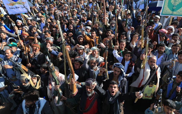Supporters of the Houthis brandish their weapons during a protest against Saudi intervention in Yemen on Friday